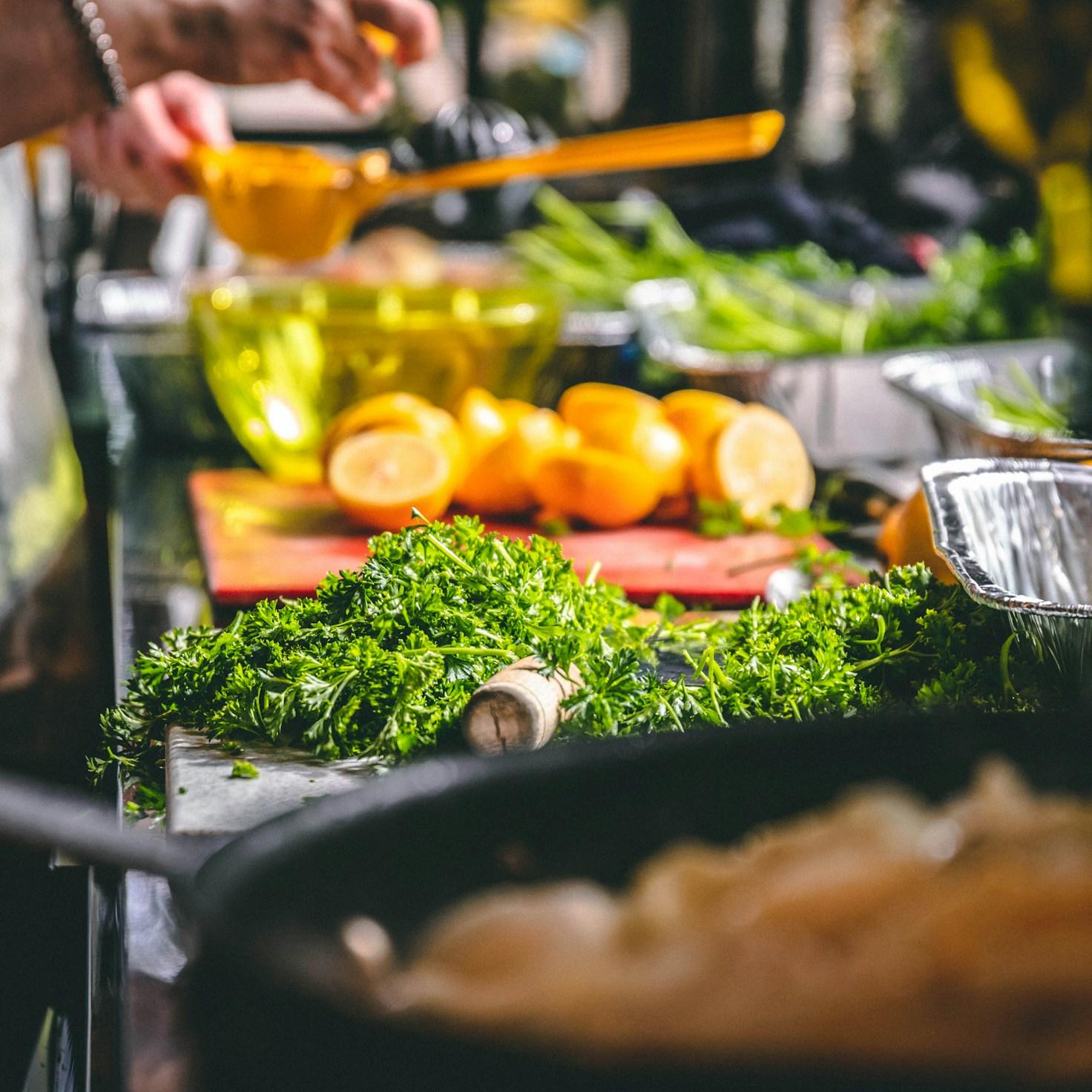 Community members cooking together in a modern kitchen, sharing recipes and techniques